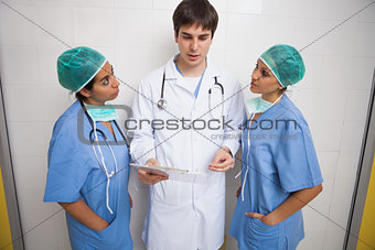 Doctor talking to two nurses