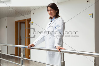 Doctor standing at the railing smiling