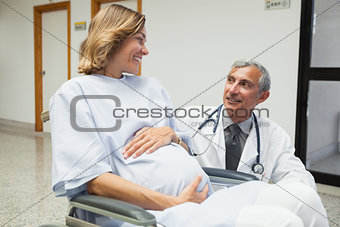 Doctor is talking to a pregnant woman