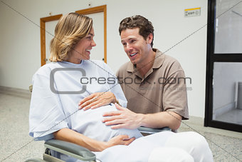 Pregnant woman in wheelchair talking with partner
