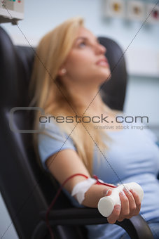 Woman sitting back while getting dialysis