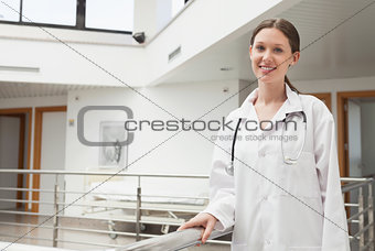 Female doctor leaning on the railing