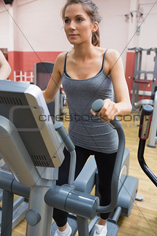Brunette stepping on a step machine