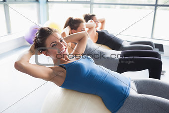 Three women doing sit-ups