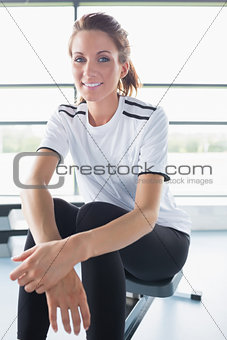 Smiling woman sitting on row machine