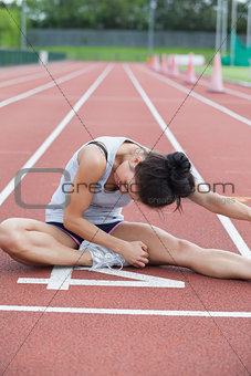 Woman stretching on a track