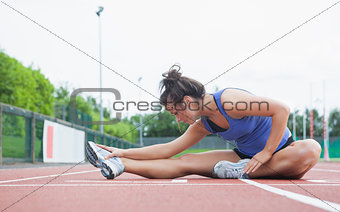Woman stretching in a stadium