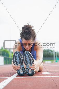 Woman stretching out on a track
