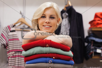Woman leaning on clothes smiling