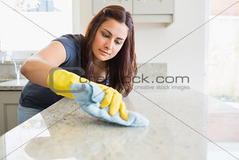 Concentrated woman scrubbing the bar