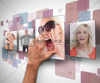 Male hand selecting photo from digital wall