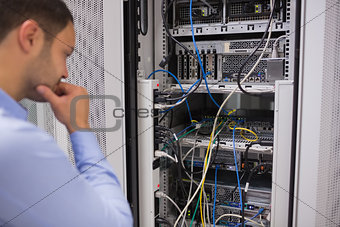 Man looking at rack mounted servers