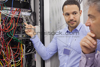 Two technicians looking at wiring