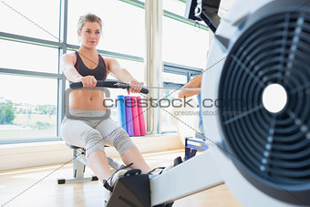 Woman exercising on row machine