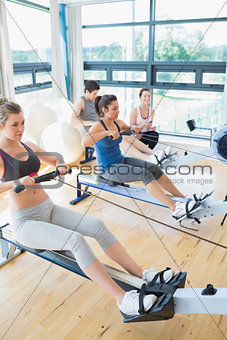 Focused people sitting at the row machine