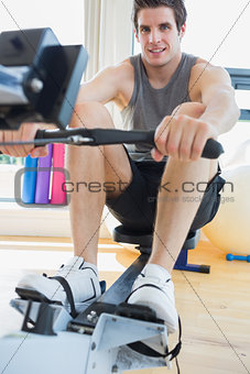 Man working out on row machine