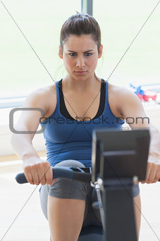 Focused woman at the rowing machine