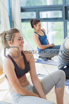 Woman sitting at the row machine laughing