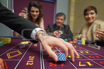 People sitting at the table placing bets