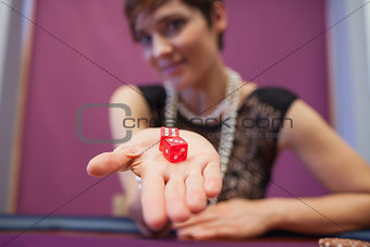 Woman holding dices at table