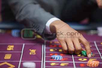 Man in casino placing bet