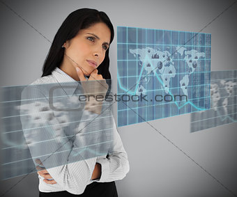 Woman standing thinking against grey background