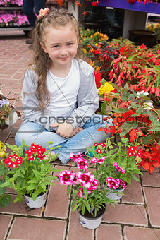 Little girl with flowers around her