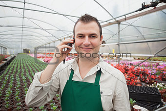 Employee on the phone in greenhouse