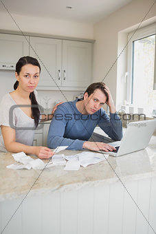 Couple calculating with the laptop