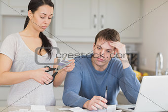 Woman cutting through a credit card