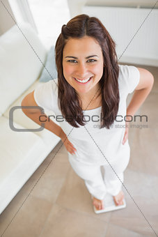 Brunette standing on weighing scales