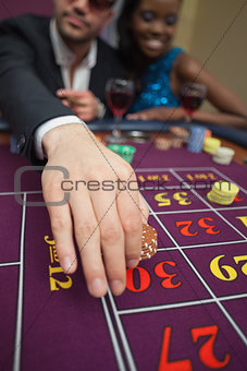 Man placing bet on roulette