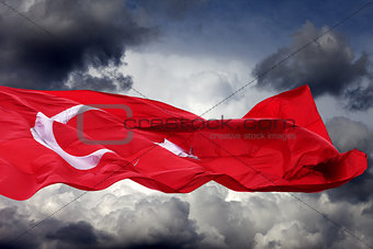 Waving flag of Turkey against storm clouds