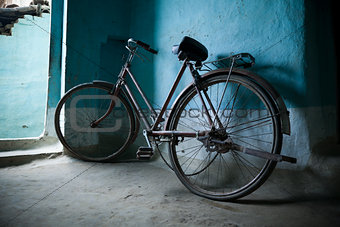 Old bicycle leaning against a wall
