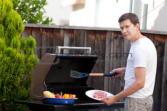 man grilling food