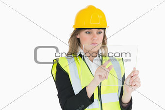 Female architect touching on a pane