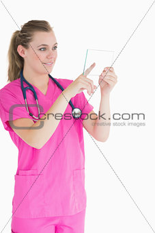 Joyful doctor touching pane