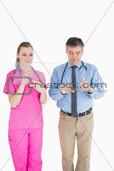 Doctors holding glass slides while being thoughtful