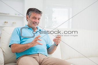 Smiling man holding an clear pane