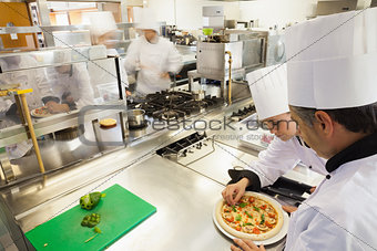 Cooks preparing pizza