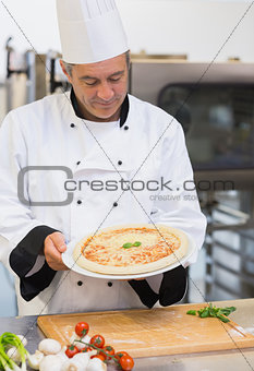 Chef admiring his pizza