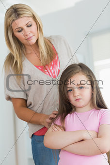 Mother trying to comfort angry daughter