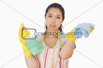 Weary woman with spray bottle and rag