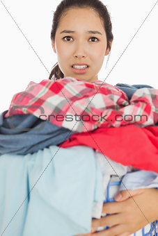 Woman overwhelmed with amount of dirty laundry