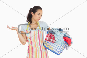 Quizzical looking young woman looking at basket