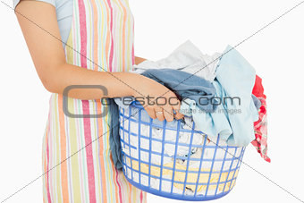 Woman holding a basket full of laundry