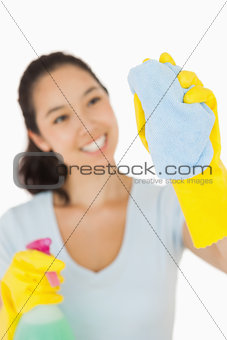 Happy woman cleaning a window