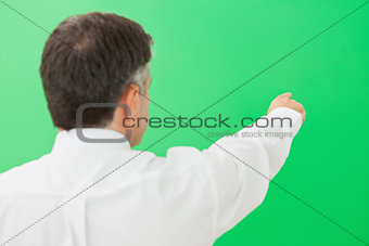 Well-dressed businessman pointing to copy space