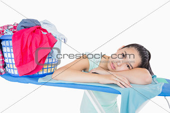 Woman with head resting on an ironing board