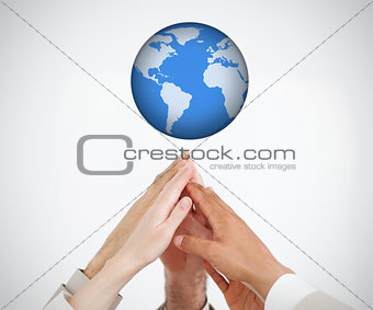 People reaching hands to globe